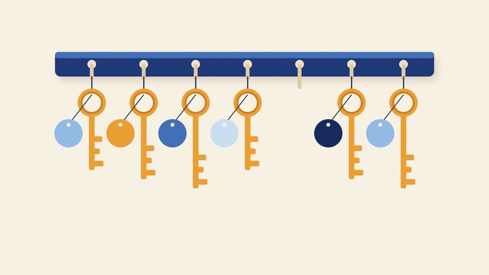 Illustration of a key rack with six keys, each with a round tag in a shade of blue or amber, and one empty hook